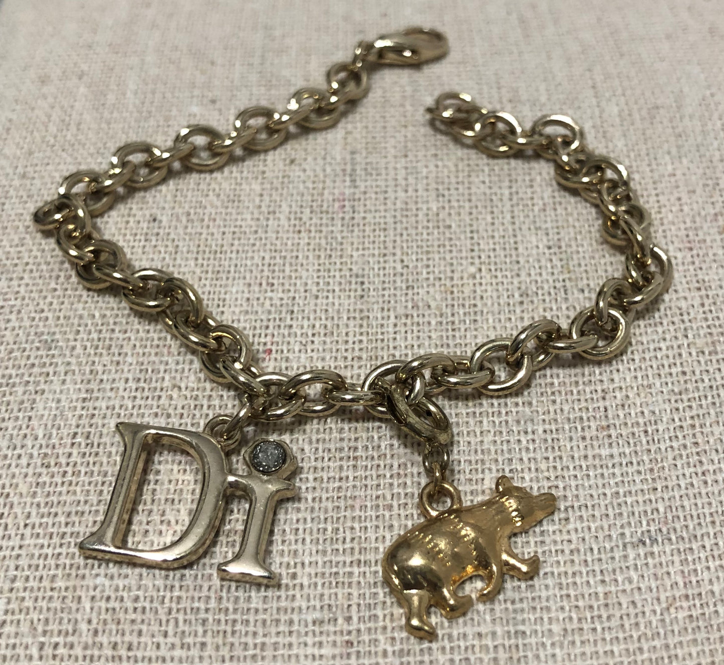 Diamonds International Charm Bracelet with a Grizzly Bear and DI Charm